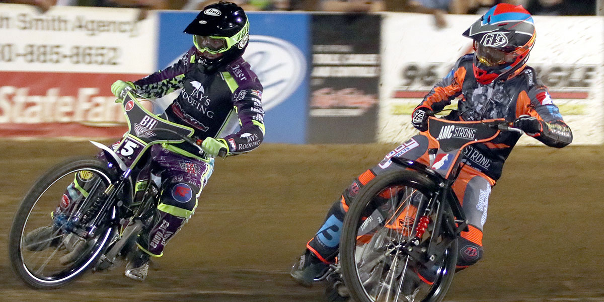 2 speedway racers mid turn