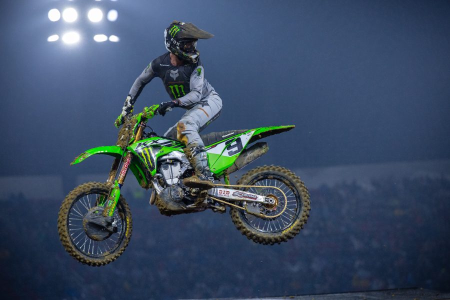 Supercross racer midair looking back at his opponents