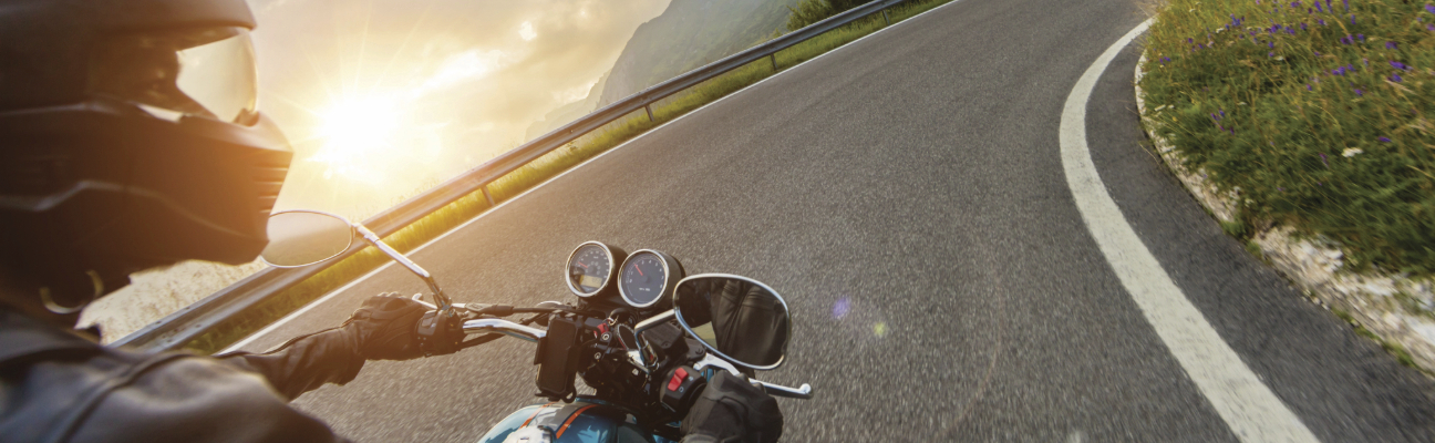 Man riding motorcycle during sunset