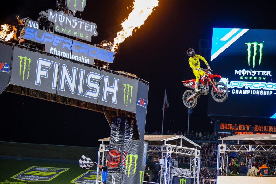 Supercross Racer Mid Air with fire cannon launching in background