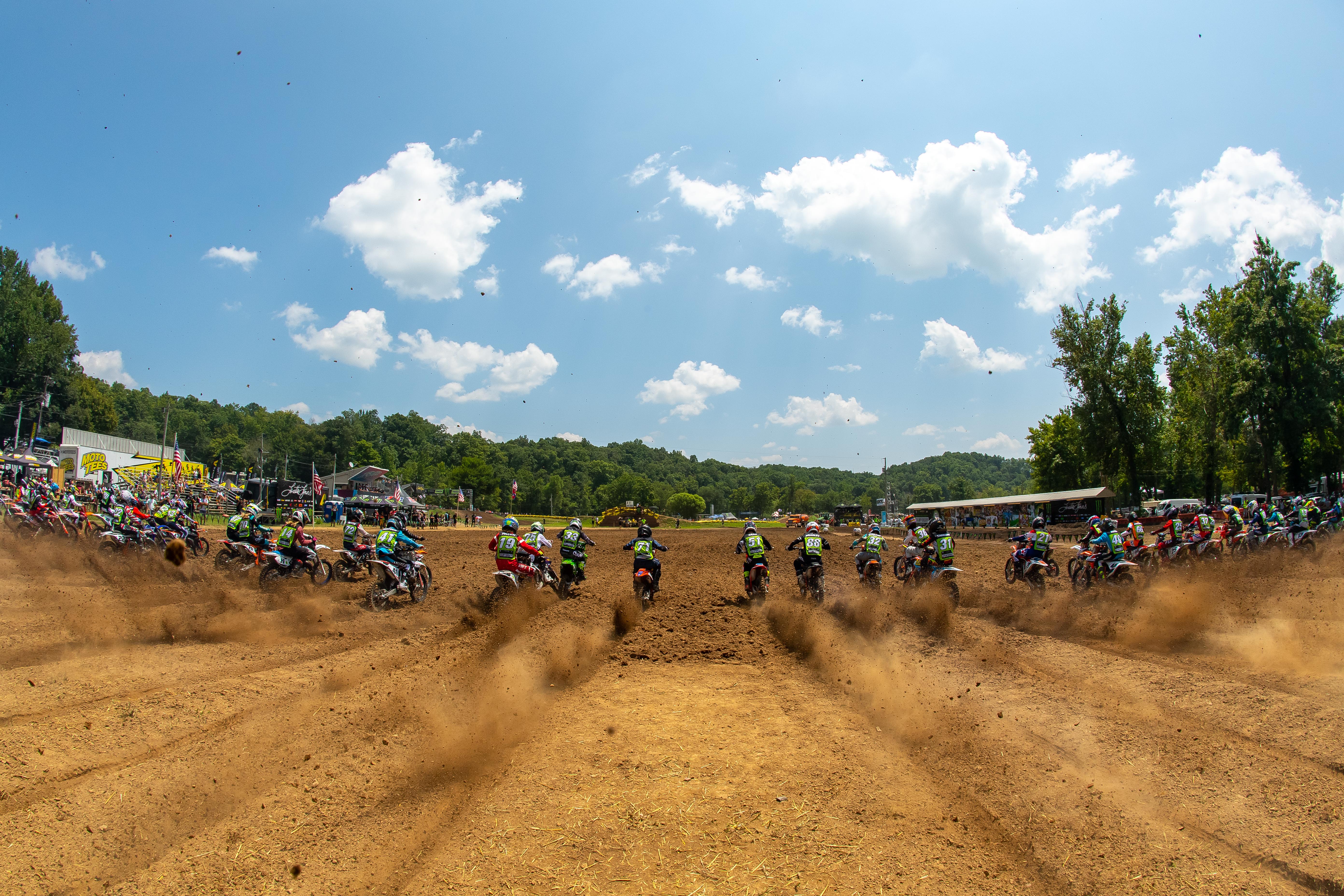 AMA Sanctioned Events- Racers on dirt track driving away from camera